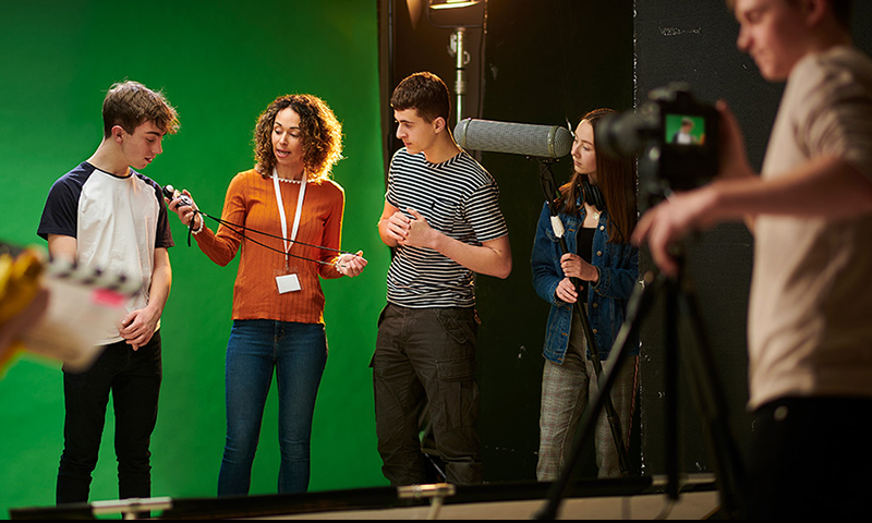 recording studio with green screen, people and camera set-up